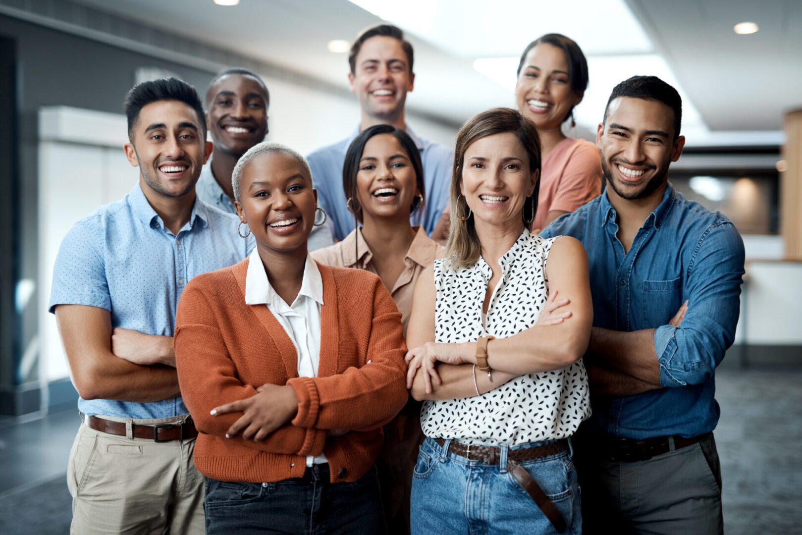 Group of colleagues standing arm in arm